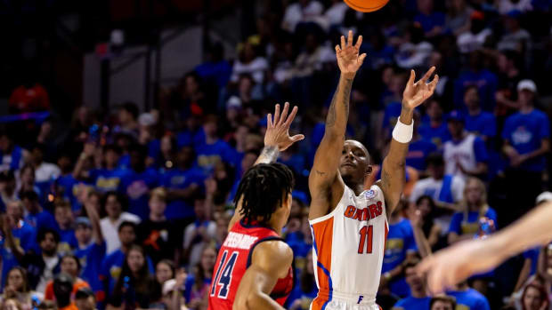 Nov 7, 2022; Gainesville, Florida, USA; Florida Gators guard Kyle Lofton (11) shoots over Stony Brook Seawolves guard Tyler Stephenson-Moore (14) during the second half at Exactech Arena at the Stephen C. O'Connell Center. Mandatory Credit: Matt Pendleton-USA TODAY Sports